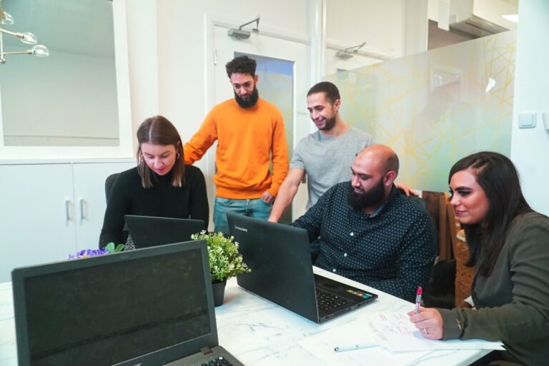 Aesthetics booking factory team looking at laptops